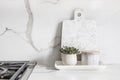 A beautiful closeup of a custom designed kitchen, with marble looking quartz countertop and backsplash