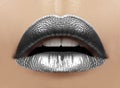 Beautiful closeup with female plump lips with silver color makeup. Christmas celebrate make-up, glitter sparkles on lip