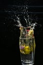 beautiful closeup photograph of water splash of lemon and flowers with black background Royalty Free Stock Photo