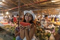 Beautiful Closeup Portrait Of Young Woman Holding Watermelon Slice While Buying Fresh Fruits On Traditional Street Royalty Free Stock Photo