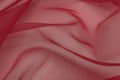 Beautiful closeup of red sateen fabric with textile texture background Royalty Free Stock Photo