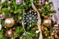 Beautiful closeup of a silver snowflake  and other decorations on a Christmas tree with lights Royalty Free Stock Photo