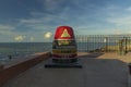 Beautiful closeup view of Southernmost Point Buoy on blue water of Atlantic OCean and blue sky background. Tourist attraction.