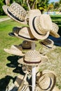 Beautiful closeup view of various fashionable, stylish summer straw hats on metal stand