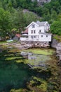 Beautiful closeup of a white house at the coastline of a pond