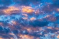 Beautiful clouds in blue sky, illuminated by rays of sun at colorful sunset to change weather. Summer cloudscape Royalty Free Stock Photo