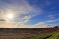 Beautiful clouds in a blue sky over a northern european agricutural field Royalty Free Stock Photo