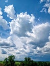 Beautiful clouds with blue sky overlooking fields and trees