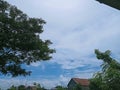 Beautiful clouds in a bright blue sky surrounded by trees and surrounding houses, Serang-Indonesia