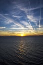 CLOUDS AND CONTRAILS IN THE SUNSET