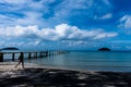 Beautiful clouds and pedestrians and bridges in the blue sky beyond the calm sea