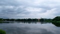 Beautiful clouds are reflected in the lake overlooking the ancient castle of the Radziwills in Nesvizh, Belarus. Summer landscape