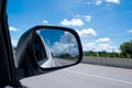 Beautiful clouds and sky landscape from the window of the car on road, reflection on the side mirror in travel the countryside Royalty Free Stock Photo