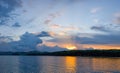 Beautiful clouds at sunset panorama of the lake with mountains on the horizon reflected on the water Royalty Free Stock Photo