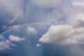 Beautiful clouds and vivid rainbow in the sky.