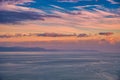 Beautiful cloudscape and dramatic sunset over mountain and sea Royalty Free Stock Photo