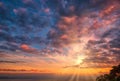 Beautiful cloudscape and dramatic sunset over mountain and sea Royalty Free Stock Photo