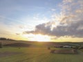 Beautiful cloudscape over the fields and farmlands near a village