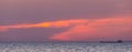 Beautiful cloudscape over the sea, scenic dramatic pink sunset