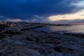 Beautiful cloudscape over sea, sunrise shot. Waves among the rocks, rocks on horizon. Crete, Greece Royalty Free Stock Photo