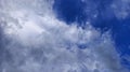 Beautiful cloudscape with soft white formations floating over a bright blue sky. Royalty Free Stock Photo