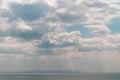 Beautiful cloudy sky over the sea with cumulus clouds and sun rays Royalty Free Stock Photo