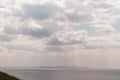 Beautiful cloudy sky over the sea with cumulus clouds and sun rays Royalty Free Stock Photo