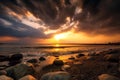 Beautiful cloudy sunset over the rocky sea shore at evening Royalty Free Stock Photo