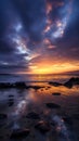 Beautiful cloudy sunset over the rocky sea shore at evening Royalty Free Stock Photo