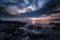 Beautiful cloudy sunset over the rocky sea shore at evening Royalty Free Stock Photo