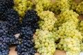 Beautiful clusters of white and blue grapes in the market Royalty Free Stock Photo