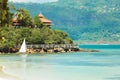 Beautiful coast with house, mountain view and a boat