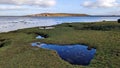 Beautiful coastal landscape scenery, wild Atlantic way, green hill, island, green grass beach at Silverstrand in Galway, Ireland Royalty Free Stock Photo