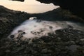 Beautiful coastal seascape scenery with volcanic rocks and small under water cave at Charco del Palo, Lanzerote, Canary Islands