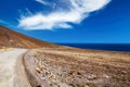 Beautiful coastal seaside dirt road, dry arid landscape, blue atlantic ocean - Road trip to Punta de Jandia, Fuerteventura