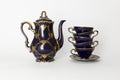 Beautiful cobalt blue colored vintage porcelain tea set with gold ornament Royalty Free Stock Photo