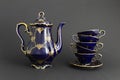 Beautiful cobalt blue colored vintage porcelain tea set with gold ornament Royalty Free Stock Photo