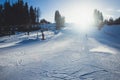 Beautiful cold mountain view of ski resort, sunny winter day with slope, piste and ski lift, with group of mountain downhill Royalty Free Stock Photo