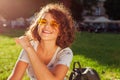 Beautiful college girl using smart phone and listening to the music in campus park Royalty Free Stock Photo