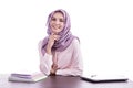 Beautiful college student wearing hijab smiling with her books a