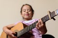 Latin girl playing electroacoustic guitar next to the amplifier Royalty Free Stock Photo