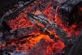 Beautiful color of burning red coals and black charred wood Royalty Free Stock Photo
