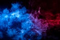 The beautiful color combination of blue, orange, violet and red hues from the substance is smoke, on a black background resembling Royalty Free Stock Photo
