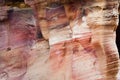 Beautiful color texture pink orange red yellow white color geological rock formations in city of Petra in Jordan Royalty Free Stock Photo