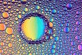 Beautiful colored abstract background from drops of oil and water. Unique mirrored backdrop. Macro of multicolored bubbles