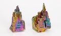 Beautiful colored brittle bismuth hopper crystals with stairstep structure on a white background