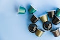 Beautiful colored coffee capsules on light blue background