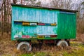 Beautiful colored wooden beehives on wheels on meadow next to the forest. Colorful moving beehive apiary.