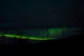 Beautiful colorful aurora borealis dancing on night sky over massive power grid structure
