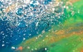 Beautiful colorful background with glitter and colored bubbles in oil and watercolor. Sparkle particles. Macro oil ink bubbles and Royalty Free Stock Photo